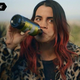 A woman in a leopard coat chugs olive oil